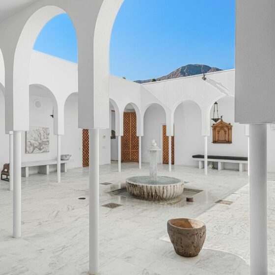 Arched marble courtyard with a central fountain at White Shadows, a Moroccan-influenced villa in Thunderbird Heights, Rancho Mirage