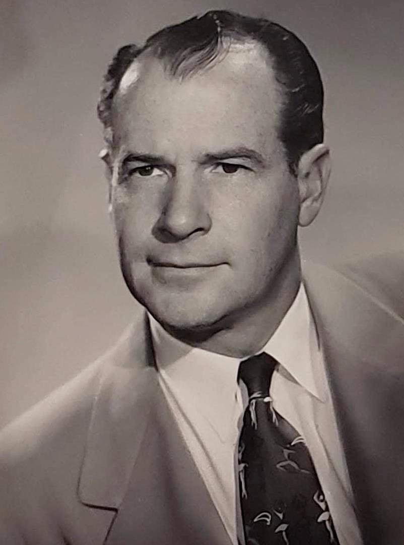 Portrait of architect E. Stewart Williams in a suit and tie